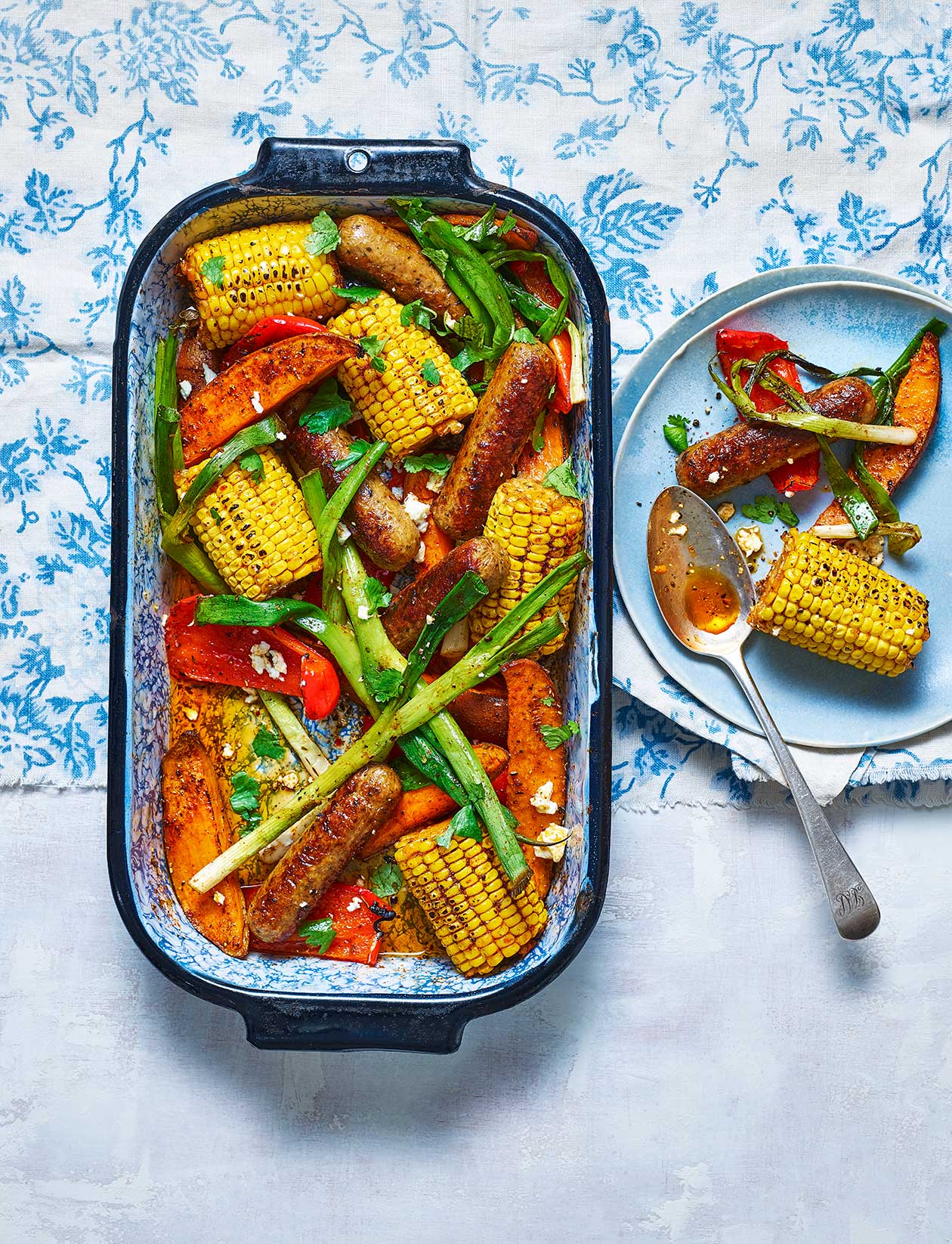 Cajun-spiced veggie- sausage traybake recipe | Sainsbury`s Magazine