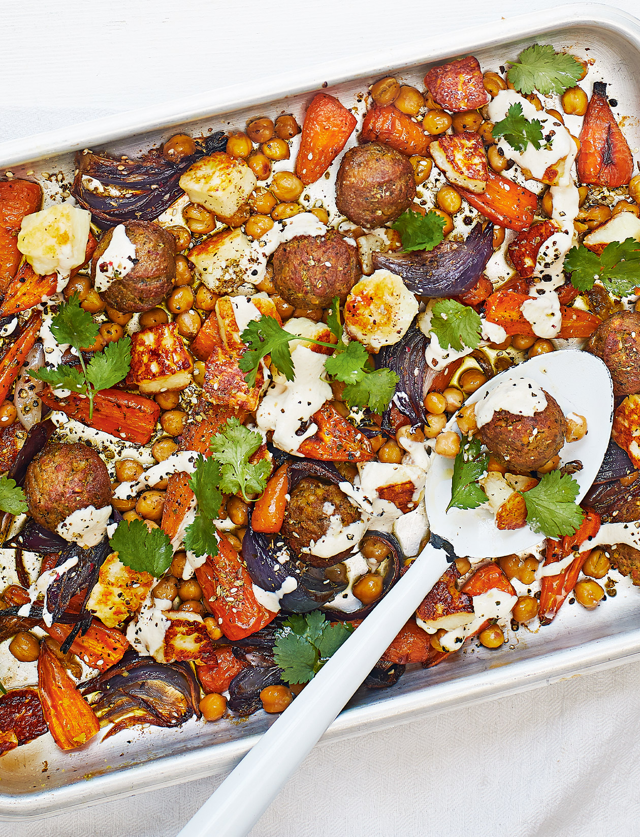 Falafel, carrot and halloumi traybake recipe | Sainsbury`s Magazine