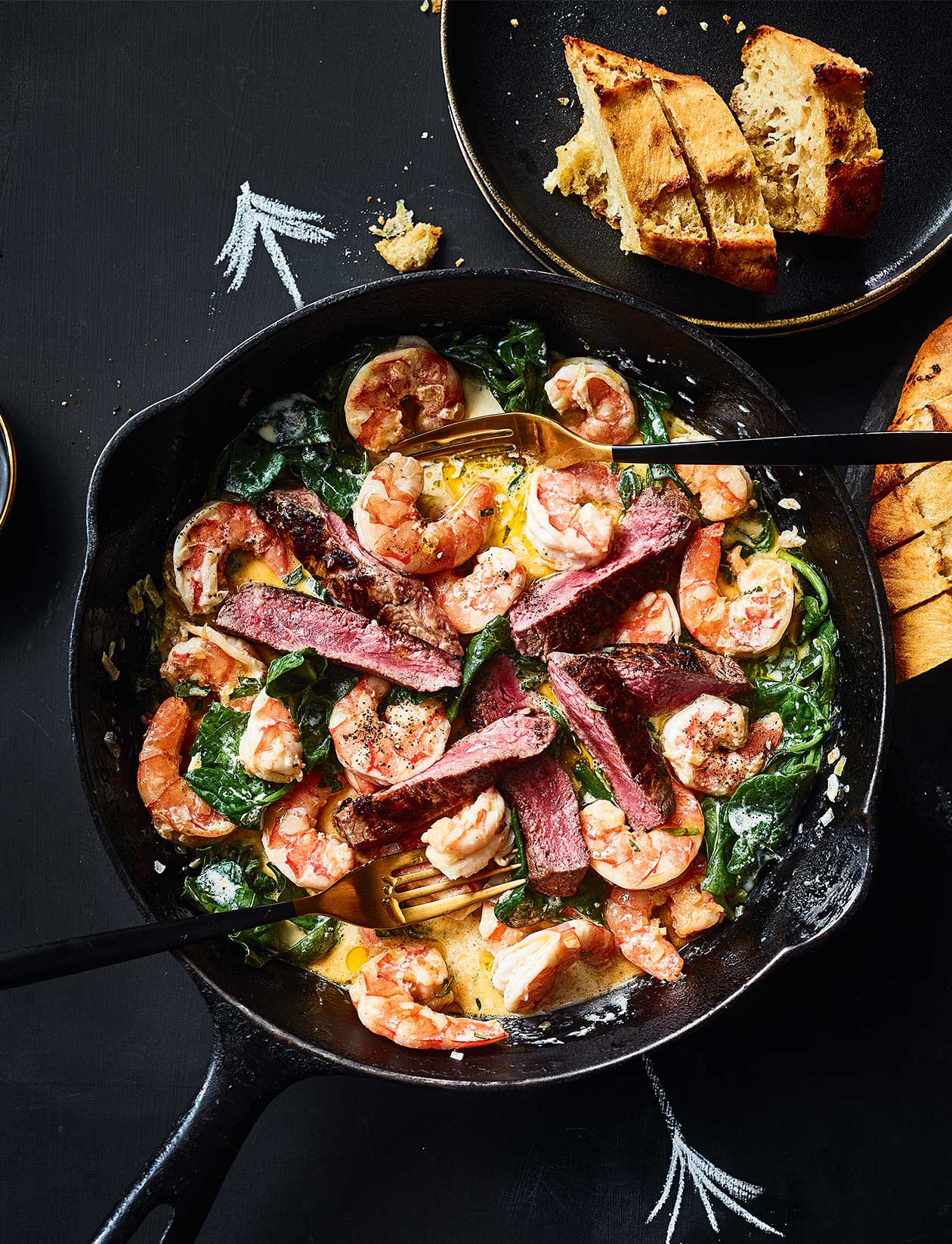 Surf and turf skillet with garlic dippers recipe | Sainsbury`s Magazine