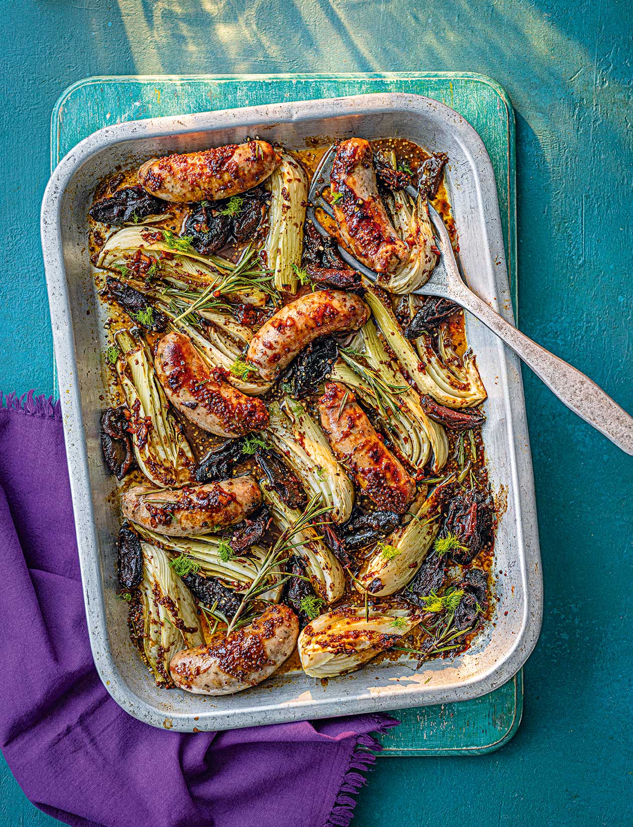 Sticky sausage, date and mustard traybake recipe | Sainsbury`s Magazine