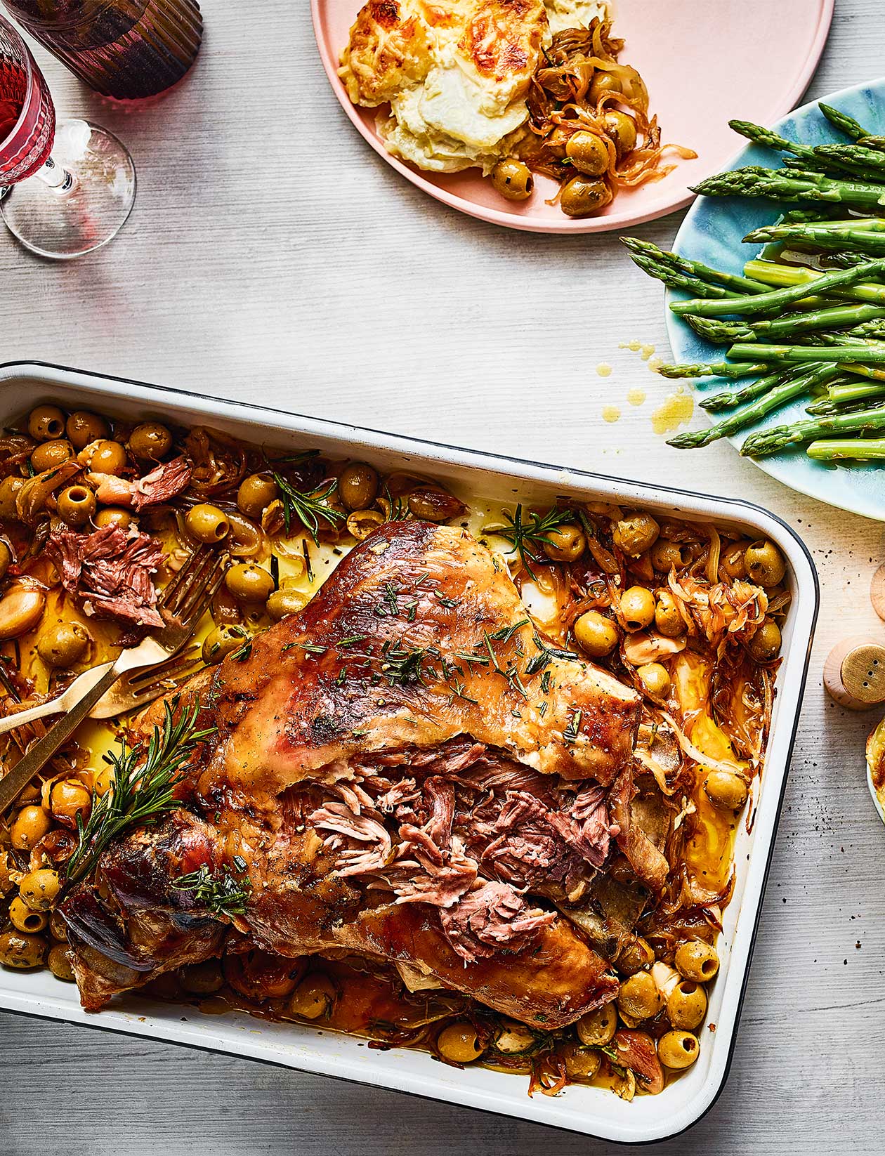 Lamb shoulder, caramelised onions and olives with butter asparagus recipe | Sainsbury`s Magazine