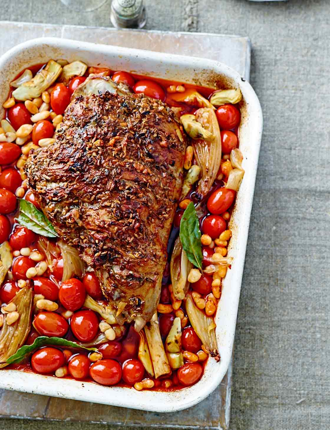 Slow-cooked spiced leg of lamb with artichokes, tomatoes and beans
