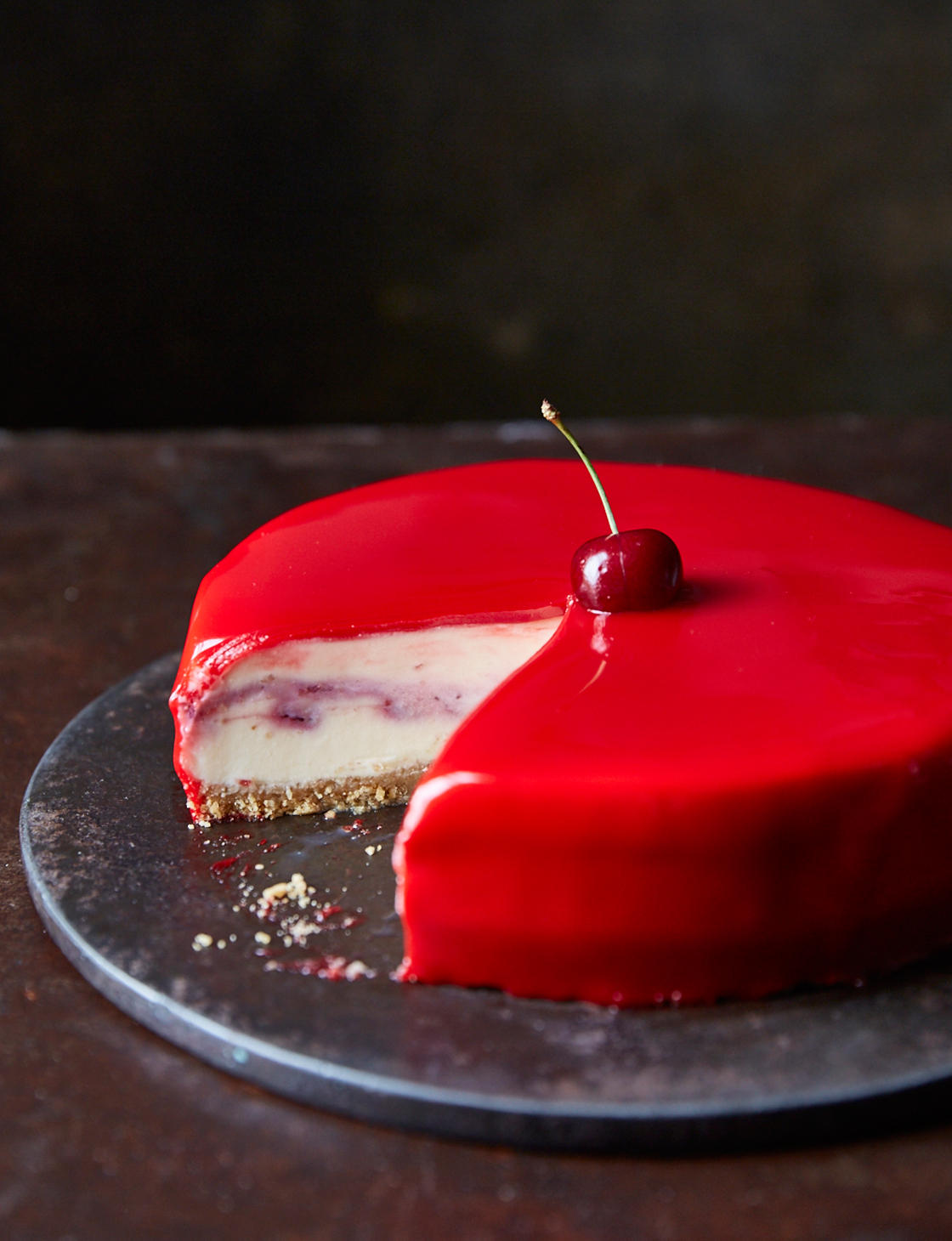 White chocolate and cherry cheesecake with a red mirror 