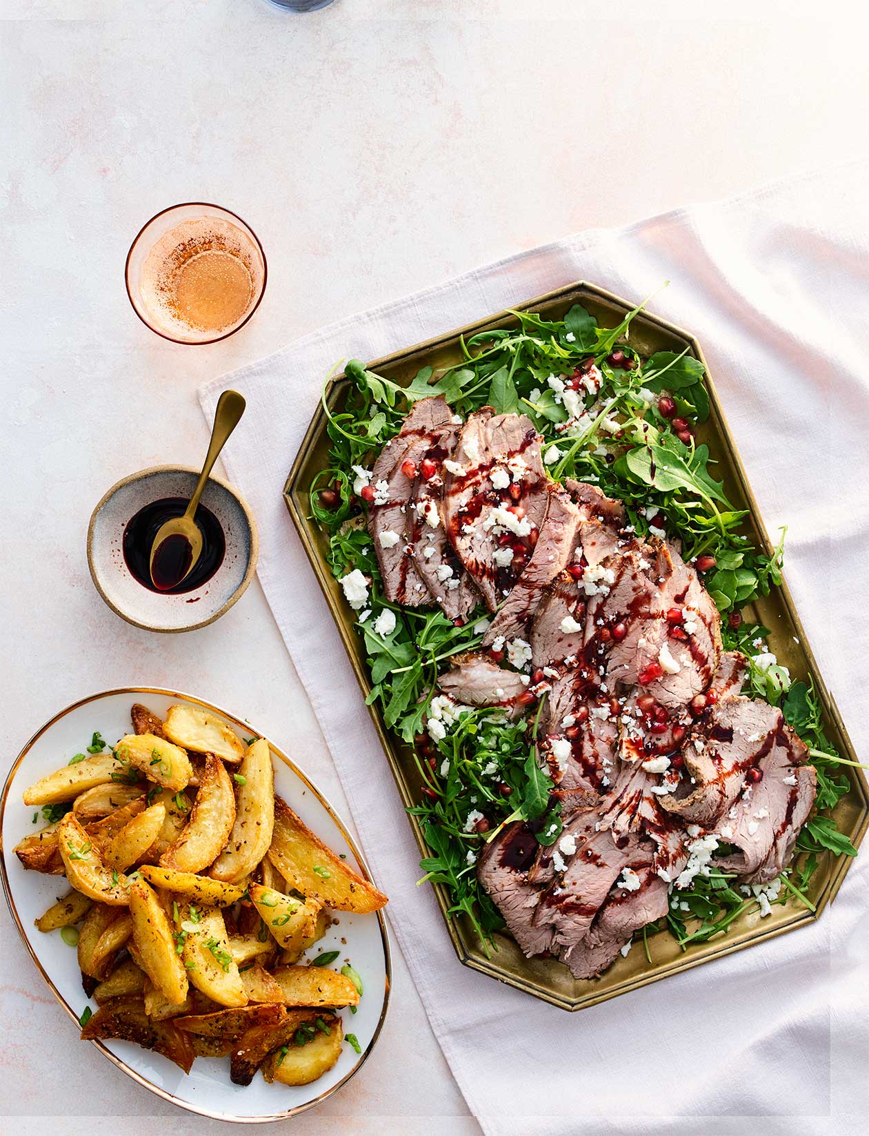 Pomegranate beef with spiced wedges recipe | Sainsbury`s Magazine