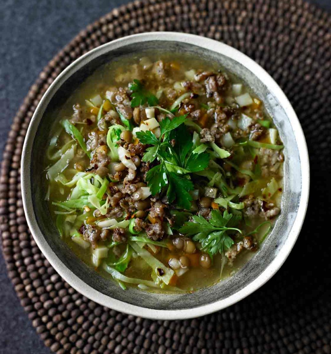 Sausage, lentil and spring greens soup