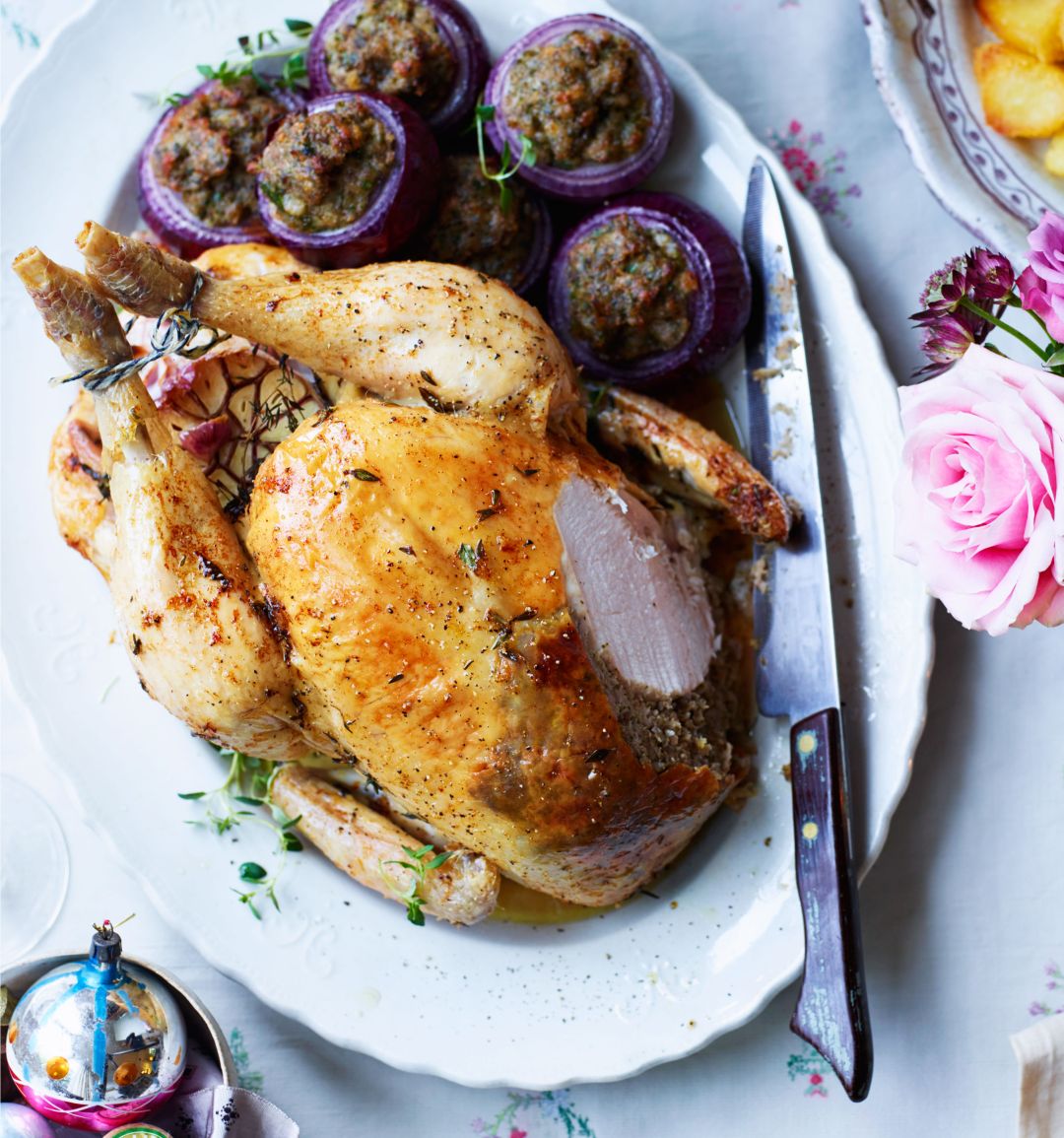 Lemon, thyme and garlic-roasted chicken with chestnut stuffing-filled red onions 