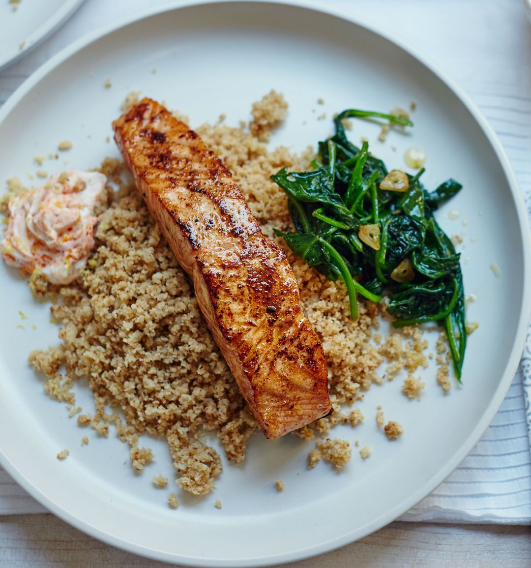 Moroccan salmon with cauliflower  ‘couscous’ and garlic spinach