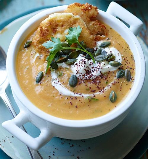 Carrot, ginger and parsley soup with mini feta fritters and pumpkin seeds