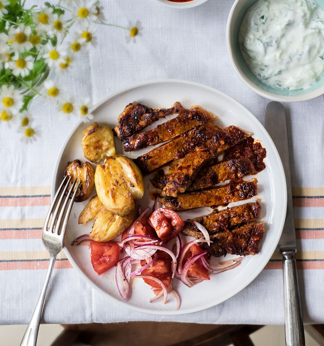 Harissa steak with tomato salad and crushed new potatoes