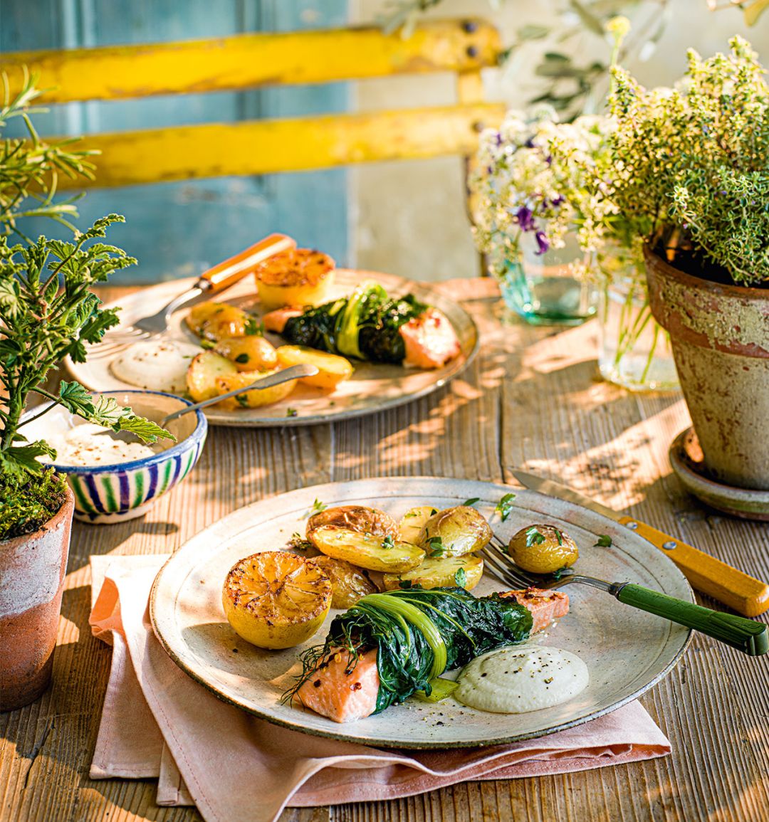 Baked salmon in chard with caramelised lemons, garlic and almond sauce