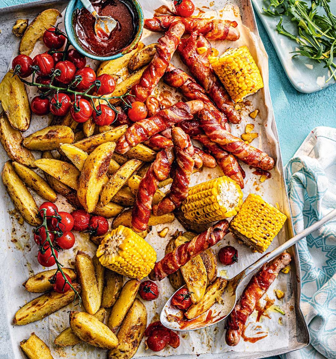 Smoky pigs-in-blankets traybake