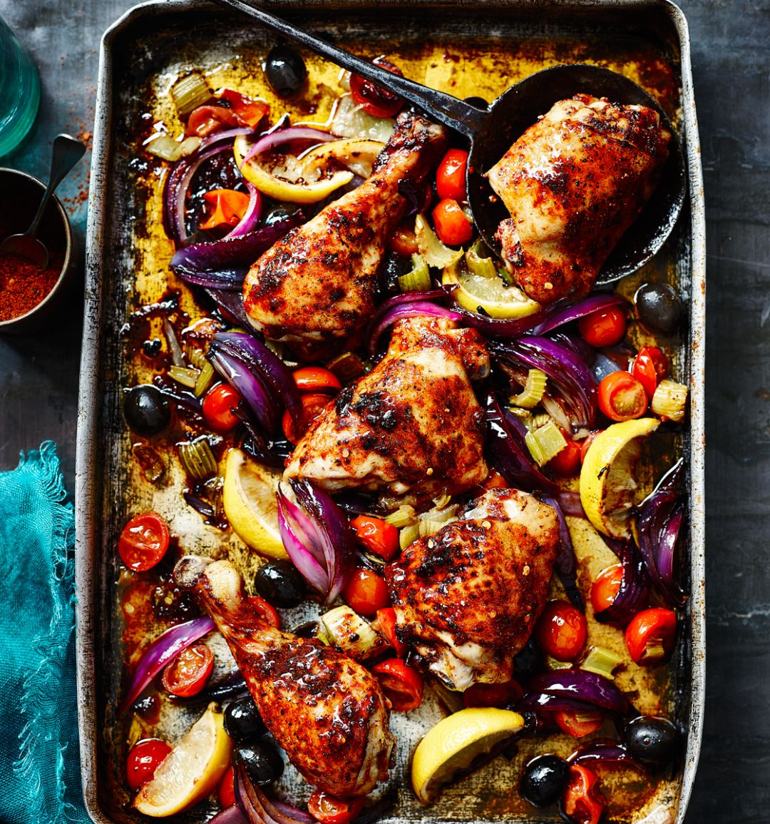 Harissa-spiced chicken legs roasted with lemons, tomatoes and celery