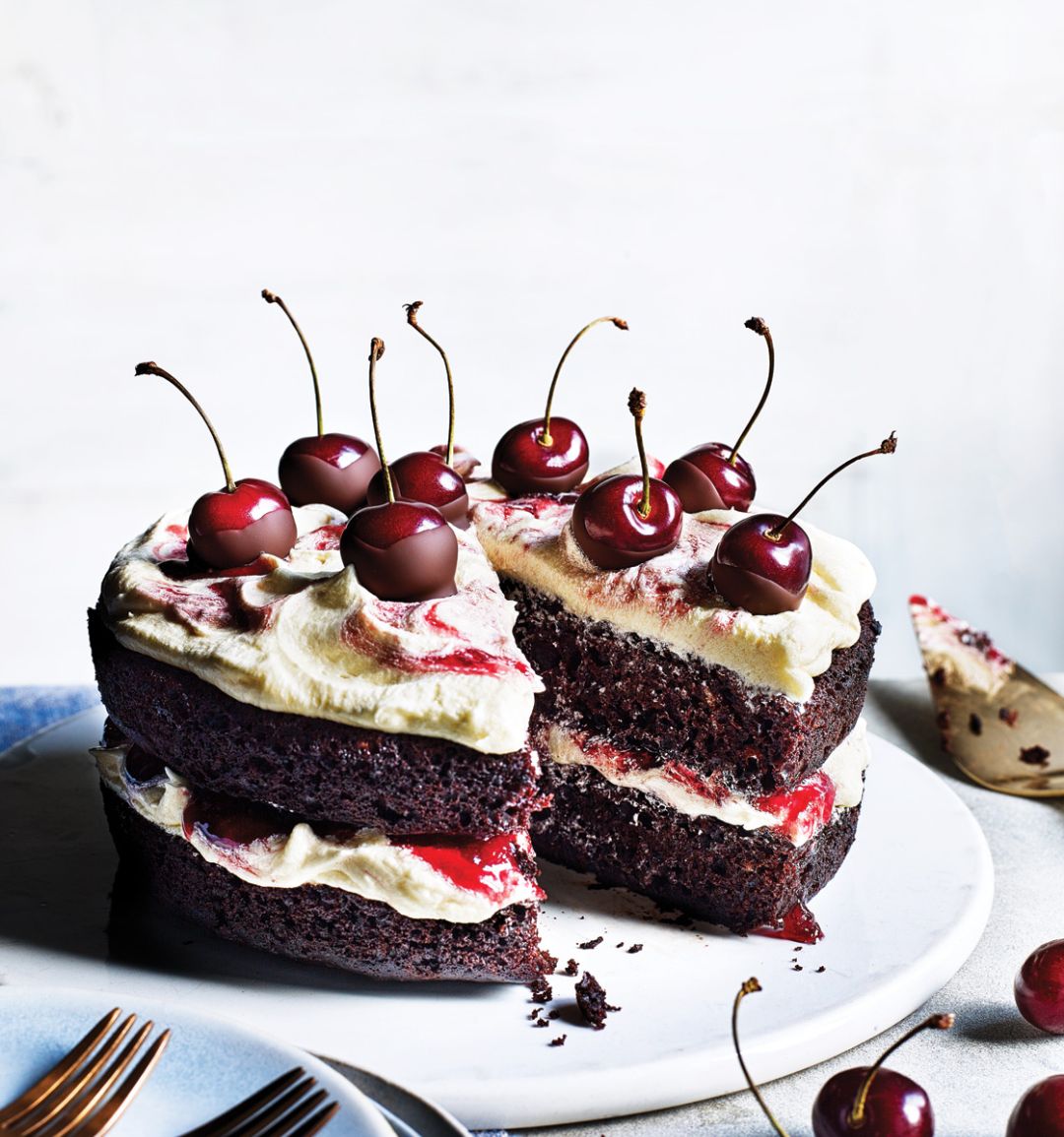 Vegan chocolate and cherry layer cake with vanilla frosting