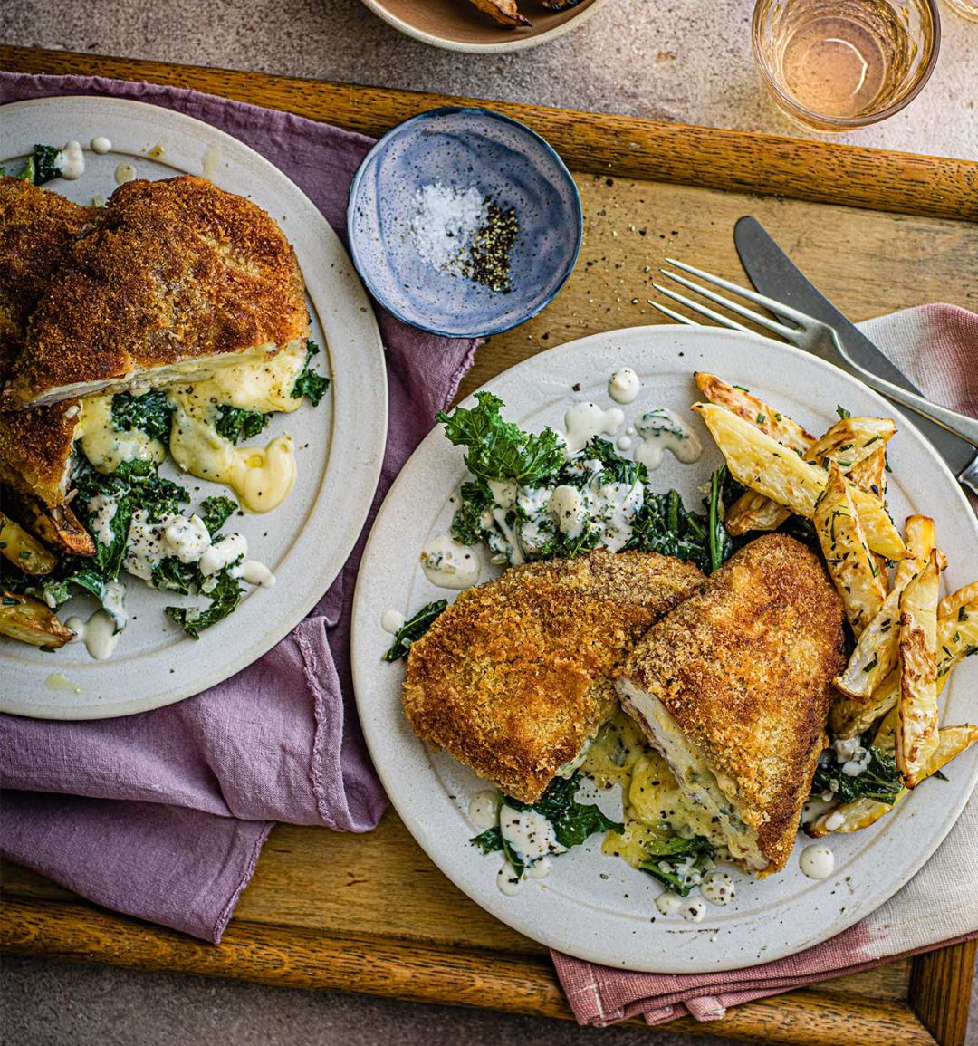 Parma chicken schnitz with cheesy kale and celeriac fries 