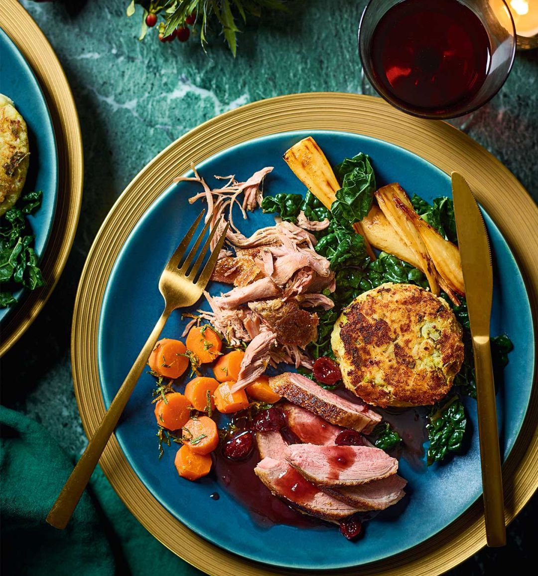 Roast and confit duck with bubble and squeak cakes, cranberry gravy