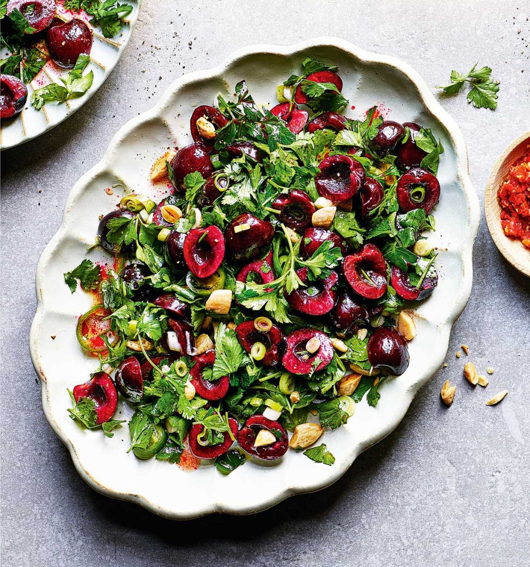Fresh herb salad with cherries and almonds