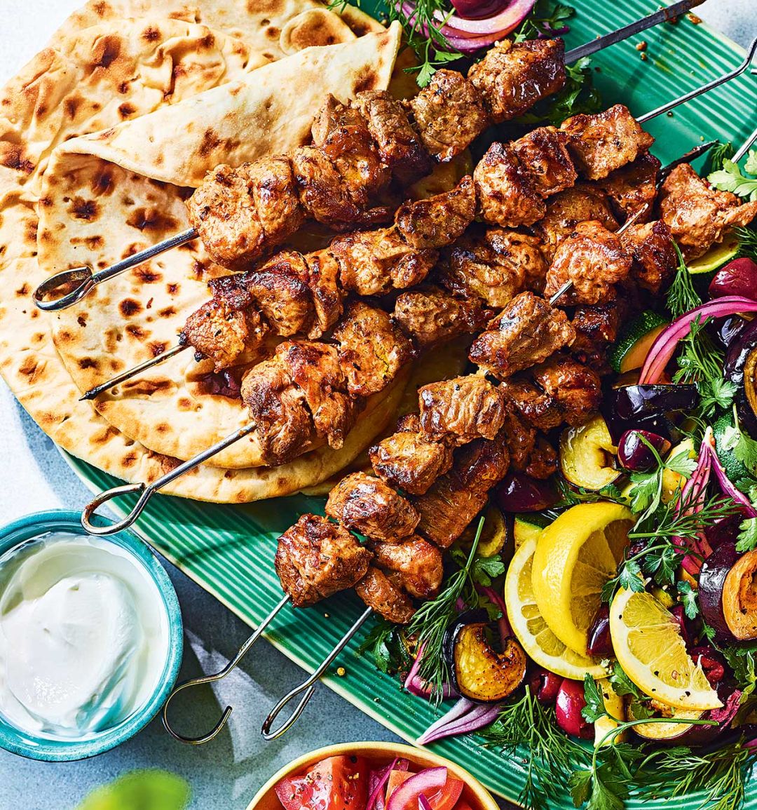 Mayo-marinated lamb skewers with aubergine, courgette and olive salad