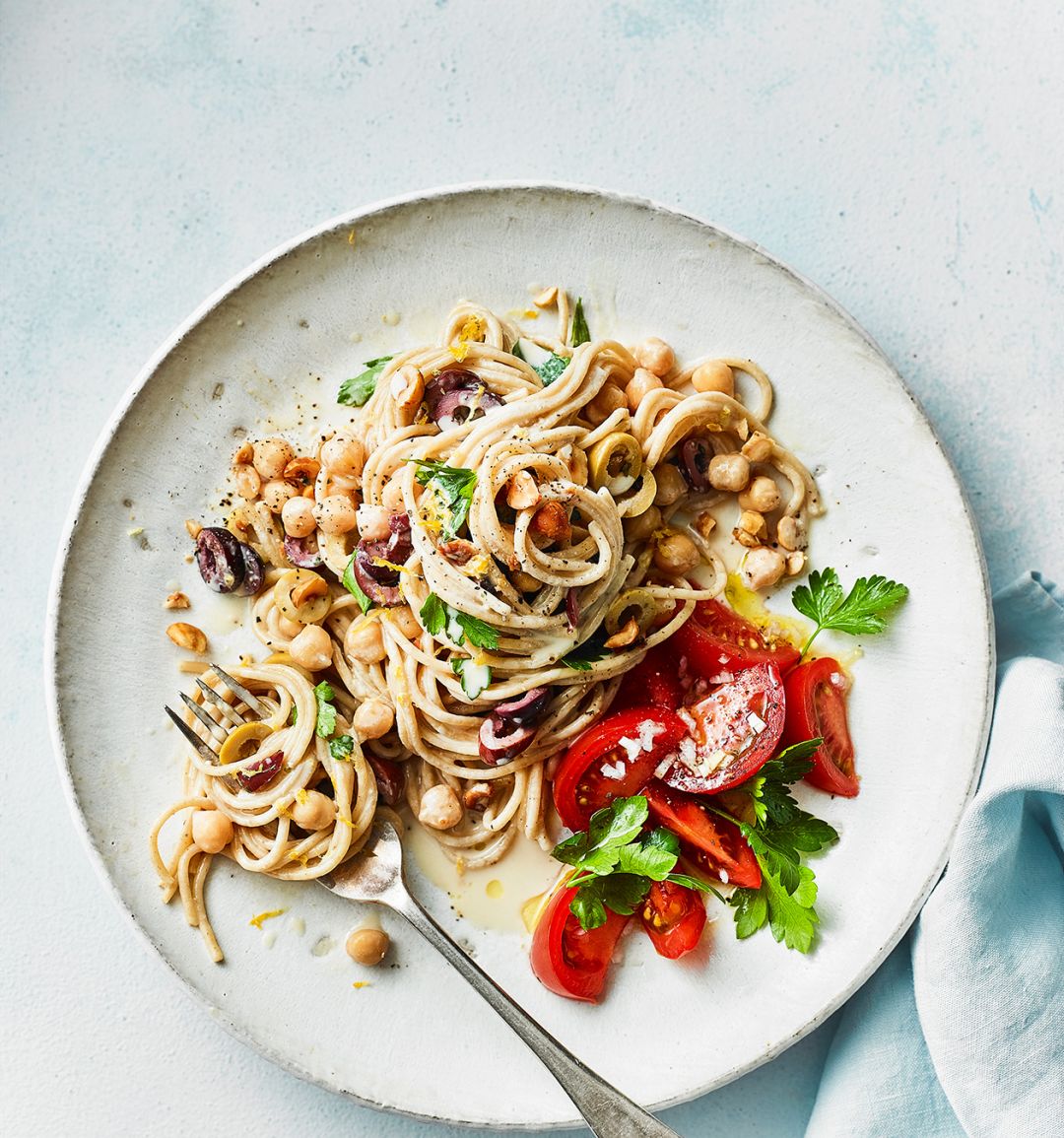 Tahini and olive spaghetti with tomato salad