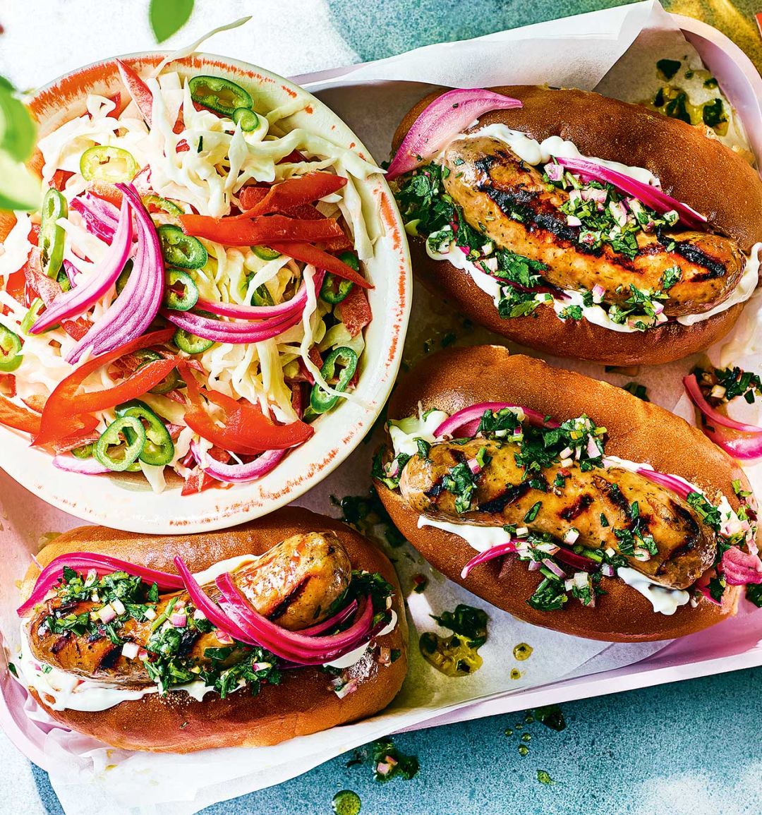 Chimichurri hot dogs with pickled pink onion and pepper slaw