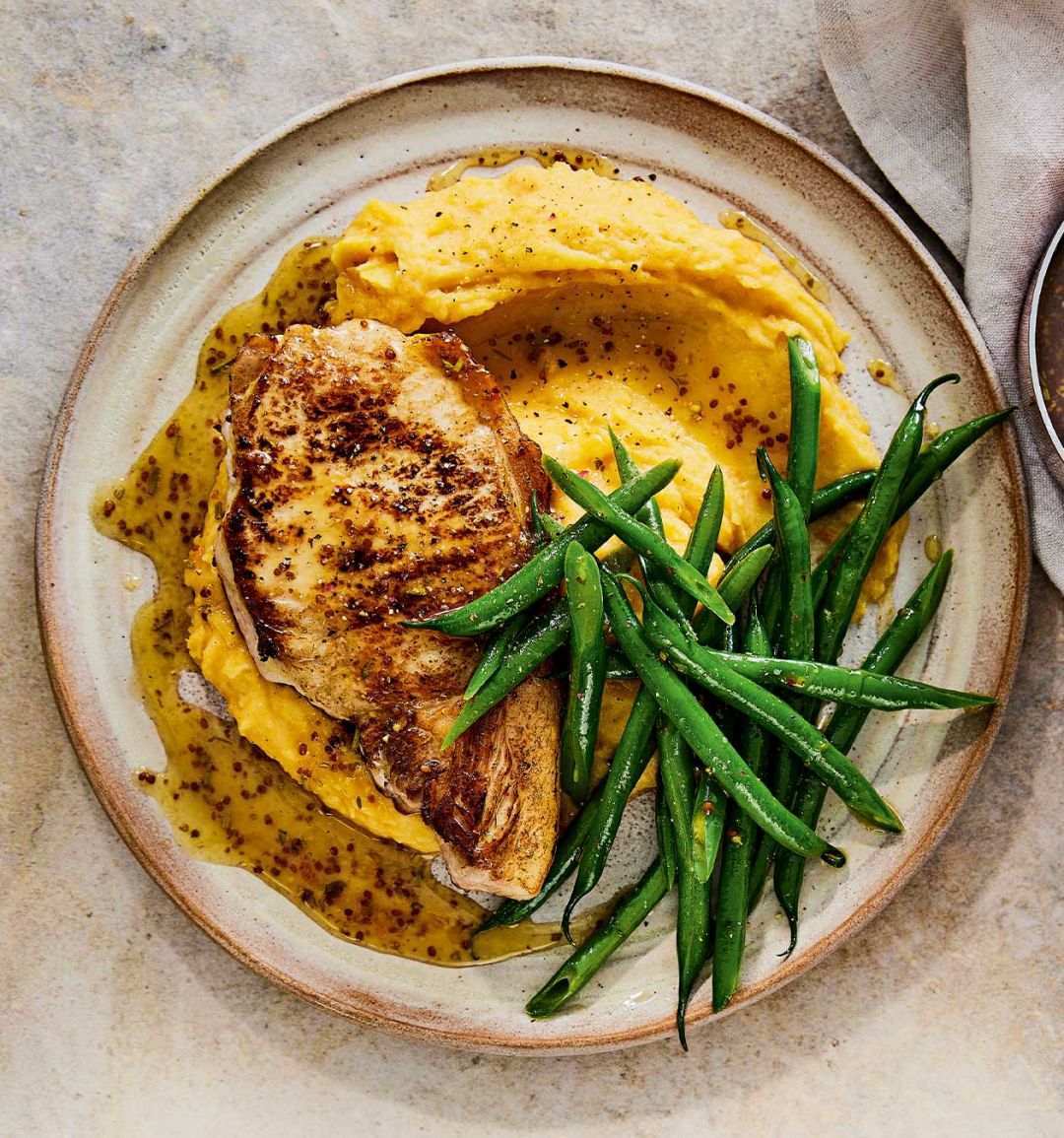 Marmalade-glazed pork chops with spiced carrot and swede mash