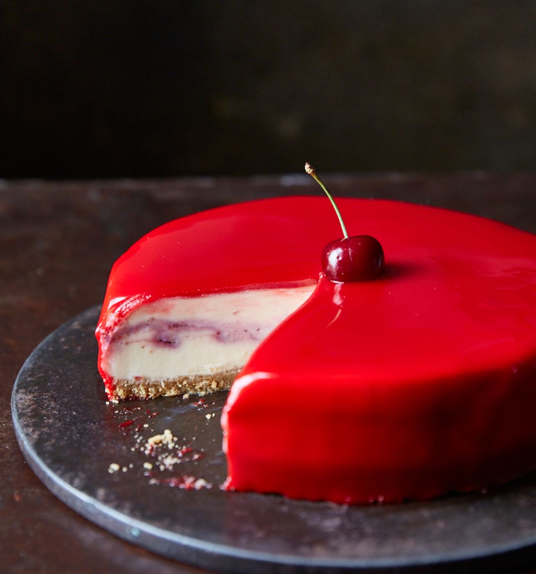 White chocolate and cherry cheesecake with a red mirror glaze