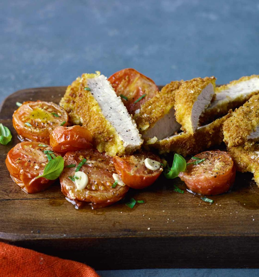 Parmesan-crumbed pork with roasted tomatoes