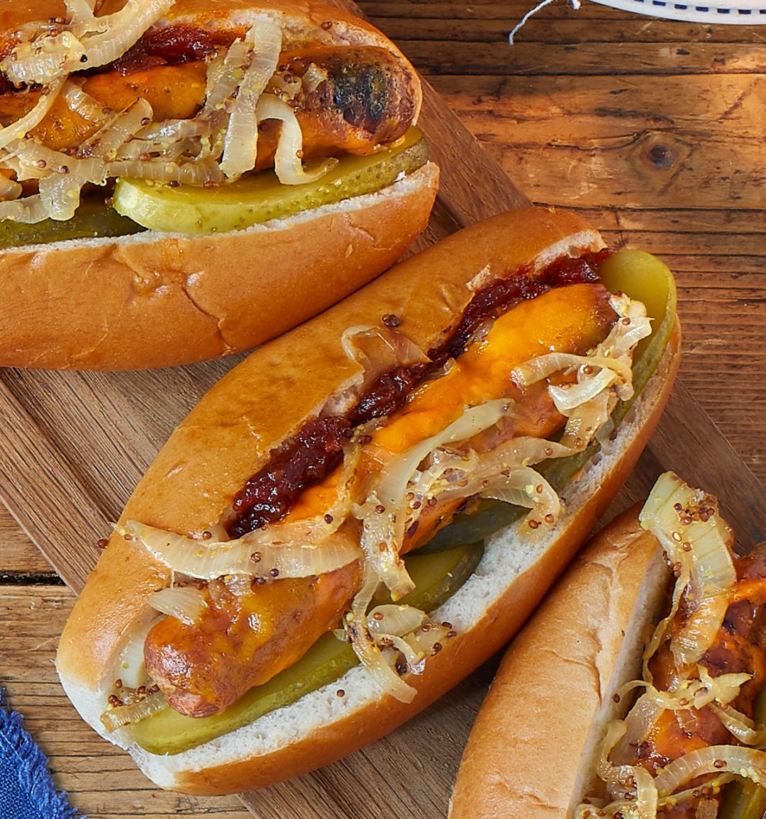 Melting cheese dogs with mustard onions