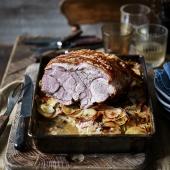 Roast pork on a bed of cider-soaked potatoes