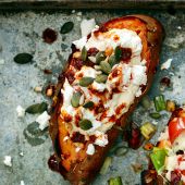 Baked sweet potato with houmous and harissa