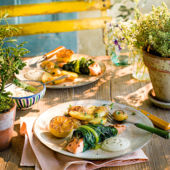 Baked salmon in chard with caramelised lemons, garlic and almond sauce