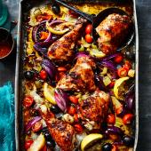 Harissa-spiced chicken legs roasted with lemons, tomatoes and celery