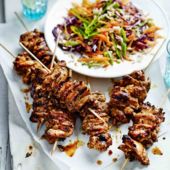 Spicy jerk chicken skewers with brown rice slaw