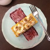 Lemon meringue tart with blackberry coulis