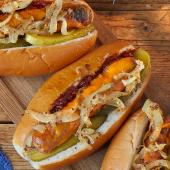 Melting cheese dogs with mustard onions