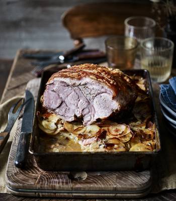 Roast pork on a bed of cider-soaked potatoes