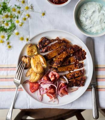 Harissa steak with tomato salad and crushed new potatoes