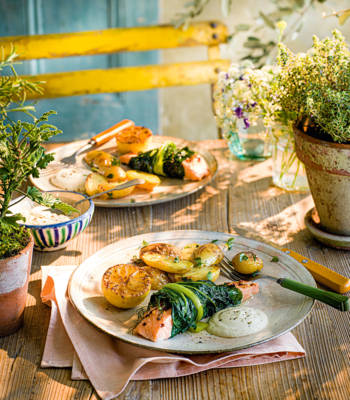 Baked salmon in chard with caramelised lemons, garlic and almond sauce