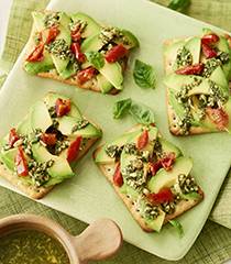 Chive crispbreads with avocado, semi-dried tomato and pesto topping
