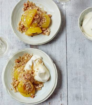 Baked plums with cardamom and honey, oat crumble and whipped cream