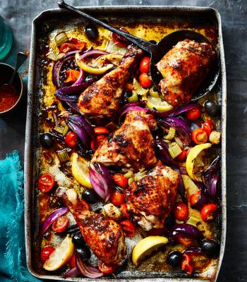 Harissa-spiced chicken legs roasted with lemons, tomatoes and celery