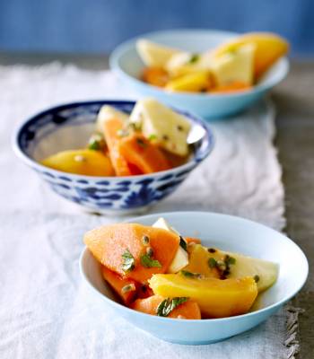 Tropical fruit salad with mint and passion syrup