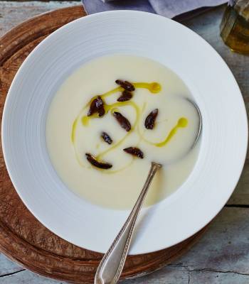 Velvety potato soup with black olives and truffle oil