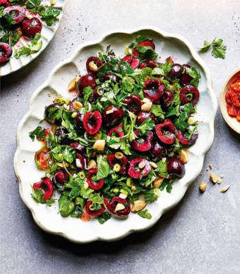 Fresh herb salad with cherries and almonds