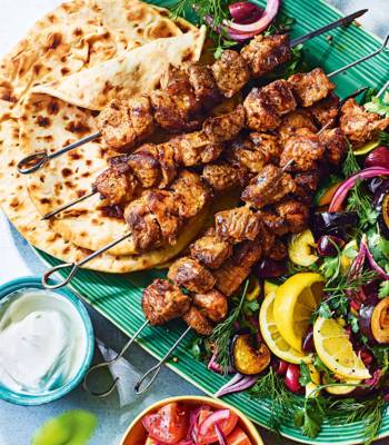 Mayo-marinated lamb skewers with aubergine, courgette and olive salad