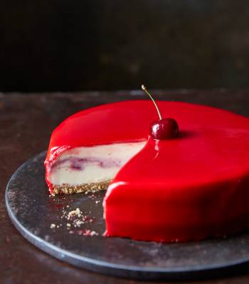 White chocolate and cherry cheesecake with a red mirror glaze
