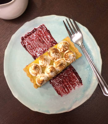 Lemon meringue tart with blackberry coulis