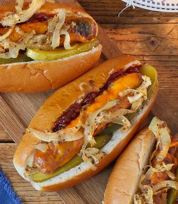 Melting cheese dogs with mustard onions