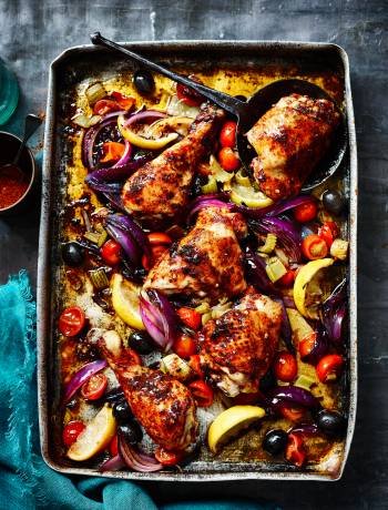 Harissa-spiced chicken legs roasted with lemons, tomatoes and celery