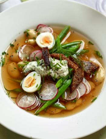 Vegetable broth with radishes, rye bread and herby yogurt