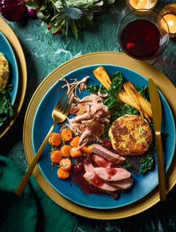 Roast and confit duck with bubble and squeak cakes, cranberry gravy